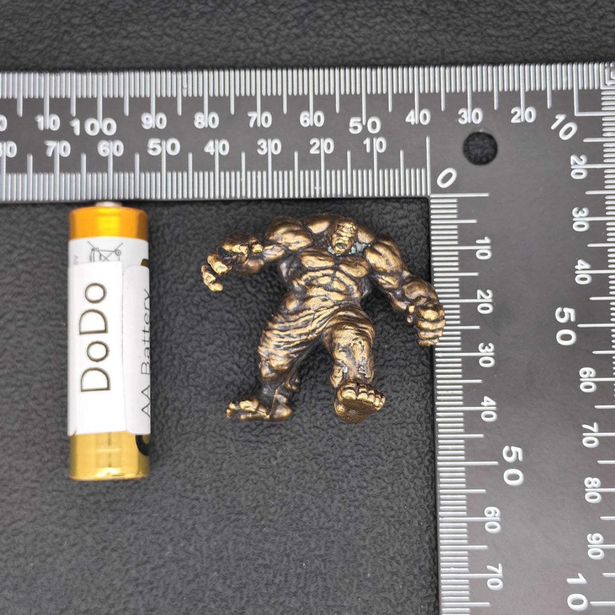 Brass Muscle Monster Figurine — Man Holding a Giant Brass Sculpture & Fantasy Desk Piece