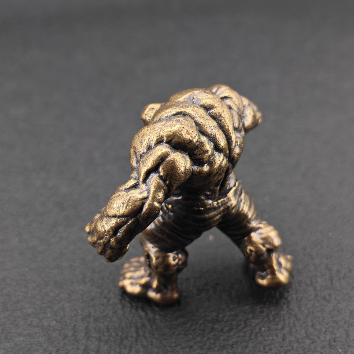 Brass Muscle Monster Figurine — Man Holding a Giant Brass Sculpture & Fantasy Desk Piece