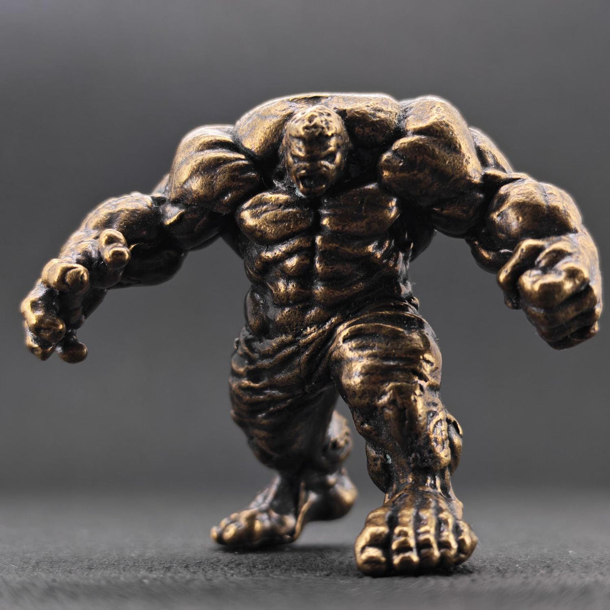 Brass Muscle Monster Figurine — Man Holding a Giant Brass Sculpture & Fantasy Desk Piece