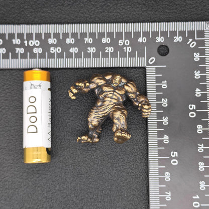 Brass Muscle Monster Figurine — Man Holding a Giant Brass Sculpture & Fantasy Desk Piece