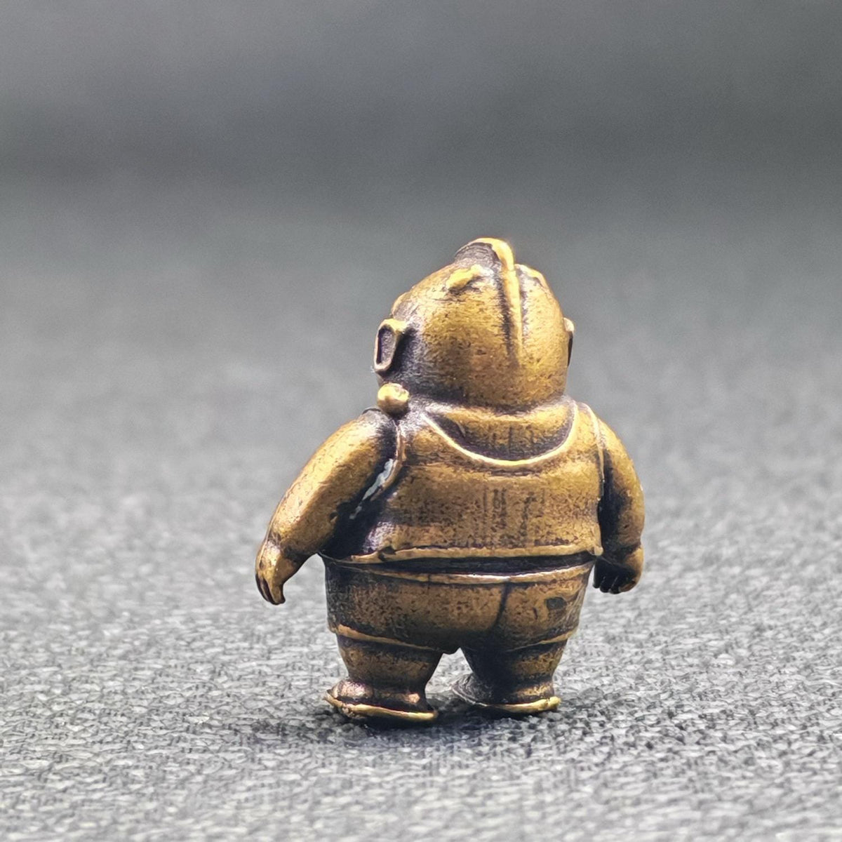 Brass Chubby Retired Hero Figurine — Parody Superhero Miniature & Novelty Desk Ornament